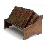 A 19th century mahogany book rack, 26.5cmW, containing eight bound volumes of The Spectator, 1793,