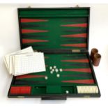 A backgammon set with dice, two leather beakers, 6 scorecard pads, labelled 34 Cadogan Square,