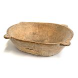 A large rustic continental chip-carved dough bowl, having four handles, 61cmL