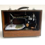 A Singer sewing machine serial no. EG002325, in hard carry case