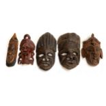 A lot of 5 carved hardwood masks, the largest 38cmL