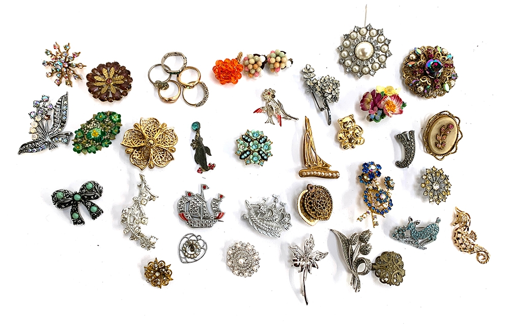 A quantity of costume brooches