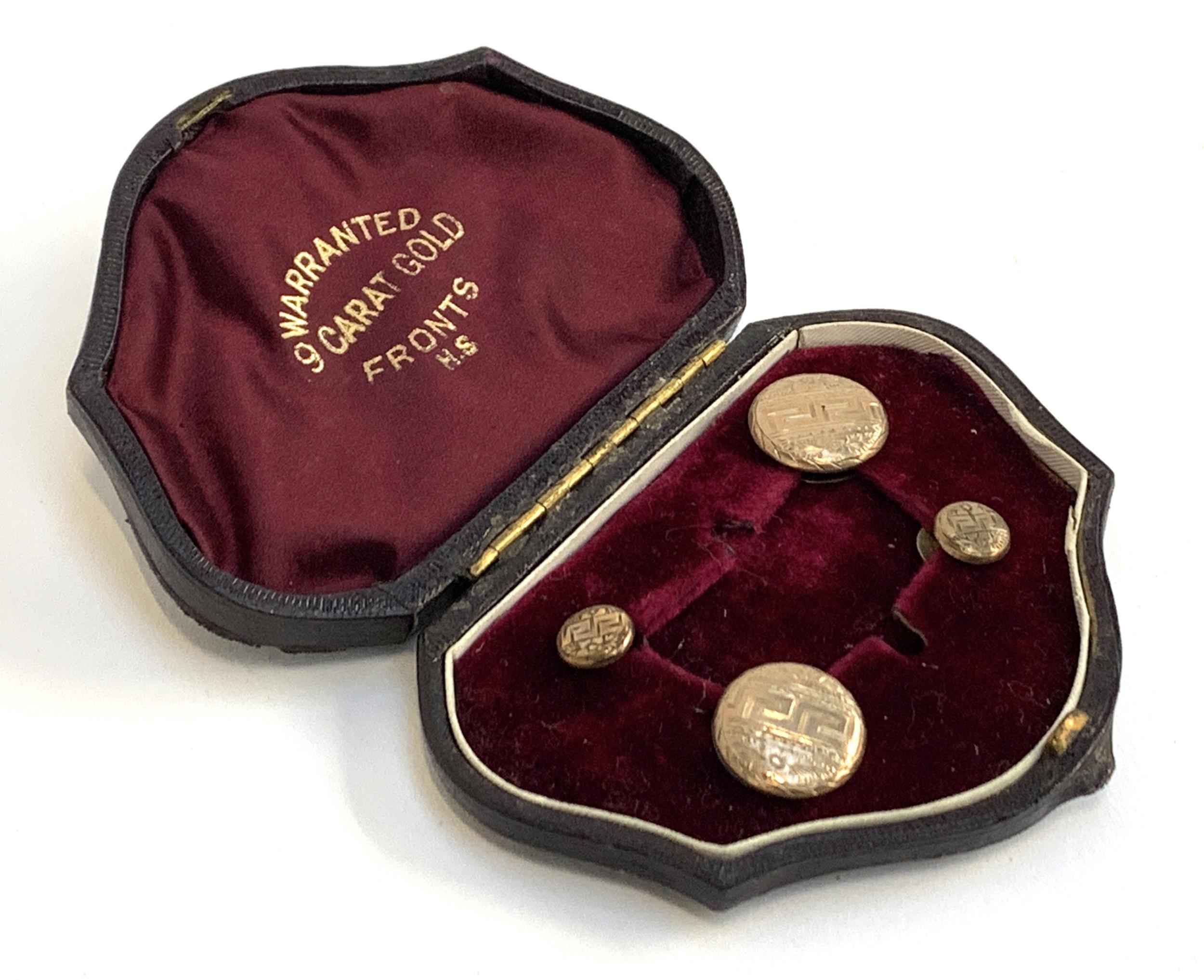 A cased set of cufflinks and studs with 9ct gold fronts with greek key decoration