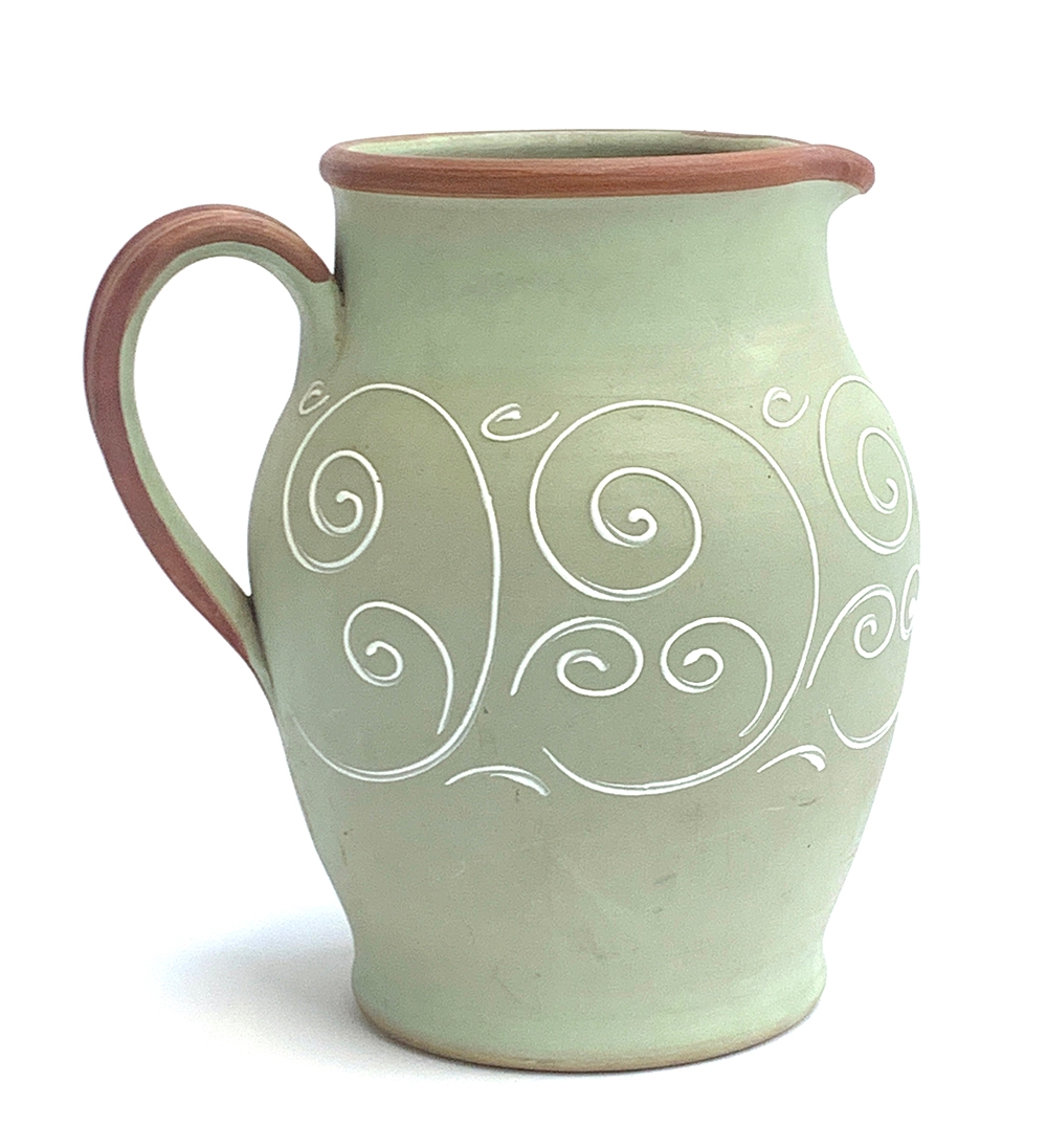 A Denby green stoneware jug, with white scrolling detail, 26cmH