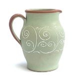 A Denby green stoneware jug, with white scrolling detail, 26cmH