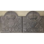 A pair of small cast iron domed fire backs, the central cartouche with fleur de lis, each 48x48cm