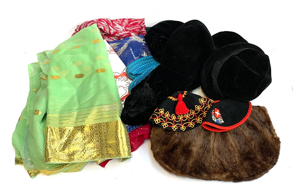 A mixed lot to include vintage hats, textiles, a fur muff and silk lined fur shawl by Faulkes,