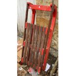 A red painted sled, 123cmL