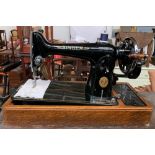 A Singer sewing machine in hooped oak carry case, s/n EC655775