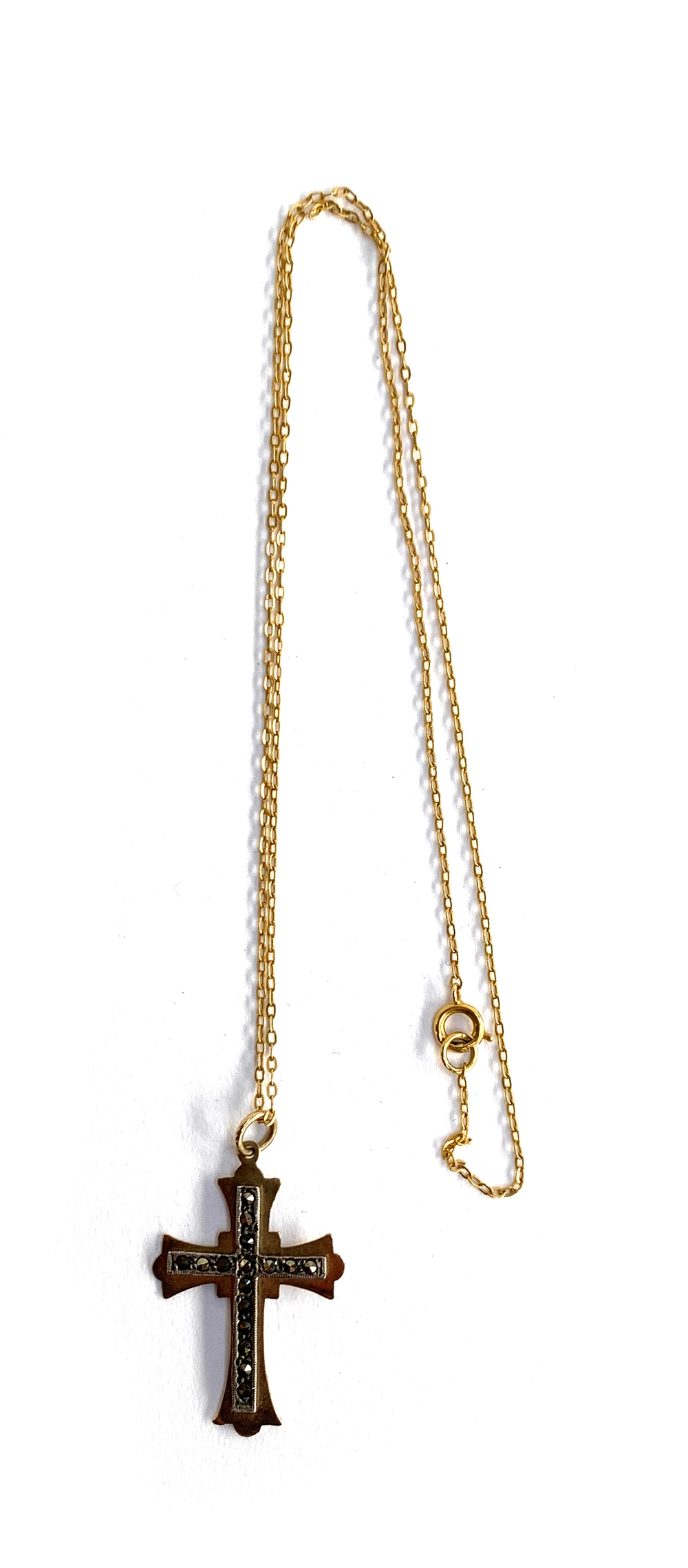 A 9ct gold chain and crucifix set with marcasites, the chain 42cm long, approx. 2.6g