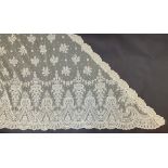 A 19th century Brussels lace shawl, of triangular shape, floral spray and swag pattern with a