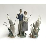 A Lladro figurine of golfers, 34cmH, together with 2 Nao figurines of cranes