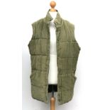 A Puffa moleskin waistcoat in green, size XL; together with another in grey, size XL (2)