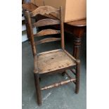 An elm ladderback chair with solid seat