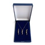 A boxed horn of plenty necklace and earring set