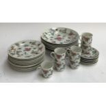 A hand painted Chinese part dinner service including 7 coffee cans and saucers, painted with flowers