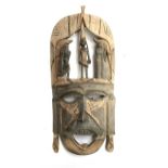 A large tribal mask carving of a warrior, 62cmL