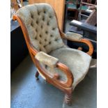 An early 20th century buttonback open armchair, on turned legs and ceramic casters