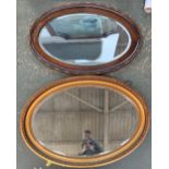 An oak framed oval wall mirror with bevelled glass, 83x54cm; together with one other gilt framed