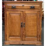 A good early 20th century oak cupboard, with moulded top over single drawer, with two fielded