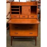A G plan style mid century student bureau, with pull out writing surface, drawers above and below,