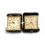 Two folding travel clocks, one by Looping