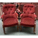 A pair of buttonback rosewood open armchairs, on lotus carved legs, on brass caps and casters,