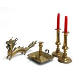 A brass Chinese dragon; a pair of brass candlesticks, each 22cmH; and a brass candle holder with