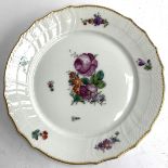 A Royal Copenhagen plate, hand painted with floral spray design, the rim heightened in gilt,