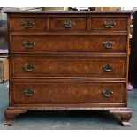 A reproduction burr walnut veneer chest of three short over three long drawers, on ogee bracket