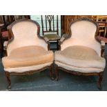 A pair of carved continental armchairs serpentine seats on carved cabriole legs, each 68cmW