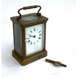 A small gilt metal carriage clock with key (af)