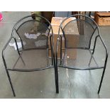 A pair of metal garden chairs