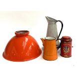 A vintage orange enamel light shade, 35cmD, together with several enamel jugs, a trivet and a tea
