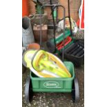 A Scotts Evengreen garden seeder, together with a garden groom