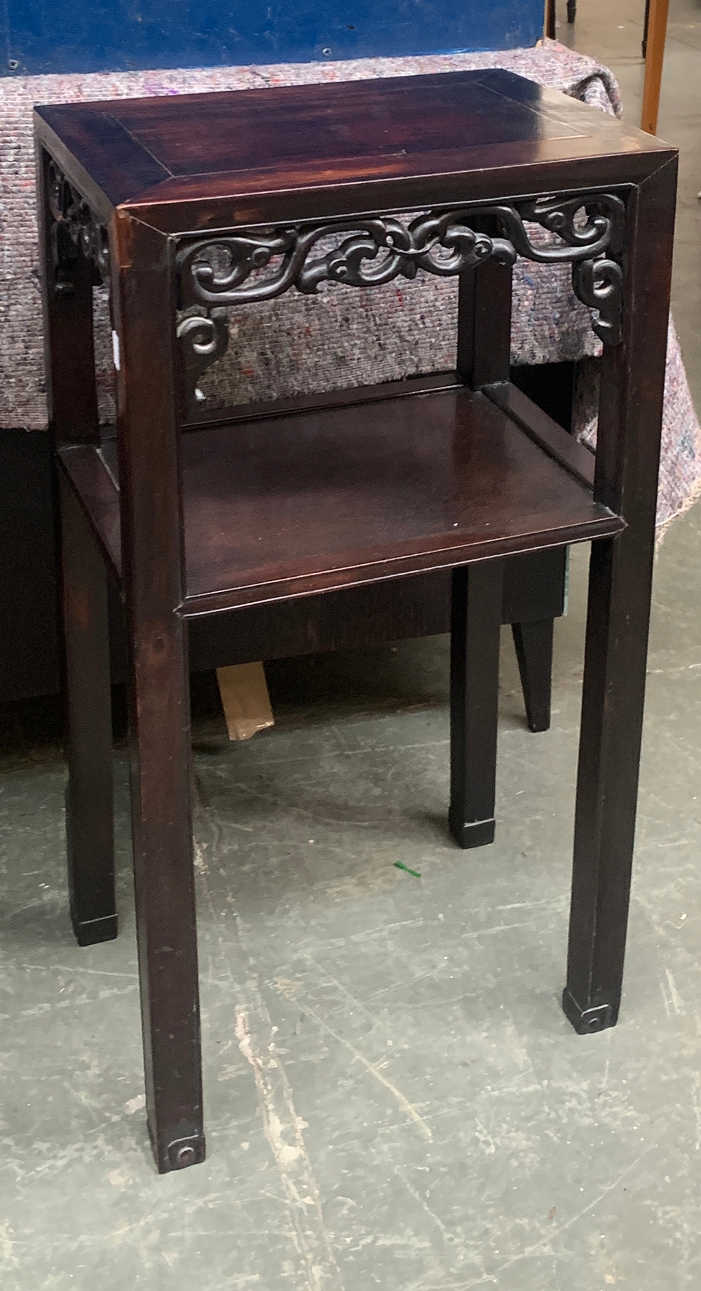 A Chinese hardwood pot stand/jardiniere, with scrolling fretwork, on square section legs with