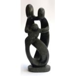 A stylised hard stone figure of a family embracing, 42cmH