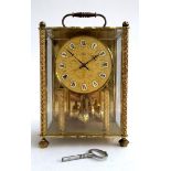 A German Koma anniversary style gilt meta 3 pane clock, 26cmH, with key