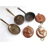 Three embossed copper moulds, 2 heavy copper saucepans and a Tapiol copper oblong pan