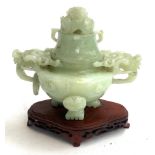 A Chinese carved jade tripod censer (af), 12cmH, on an unassociated pierced carved hardwood base