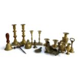 A small lot of brass candlesticks and other items to include steel corkscrew, bells etc