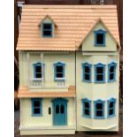 A 20th century painted dolls house, 53cmW