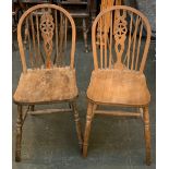 A pair of wheelback beech kitchen chairs