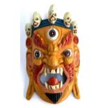 A carved Tibetan mask, 33cmL