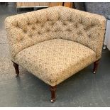 A 19th century button upholstered corner chair by Holland & Son, on turned legs and brass casters,