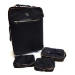 A black Anya Hindmarch suitcase together with make-up, jewellery and vanity kit bags