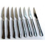 A set of seven Arcos stainless steel steak knives and one other