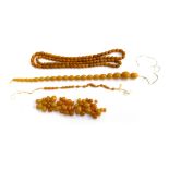 An amber bead necklace, 60cmL, together with a further two unstrung amber necklaces, total weight