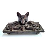 A bronze paperweight in the form of a fox, 10cmL; together with a glass paperweight depicting