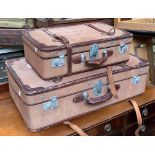 A pair of canvas and leather suitcases, 82cmW and 61cmW